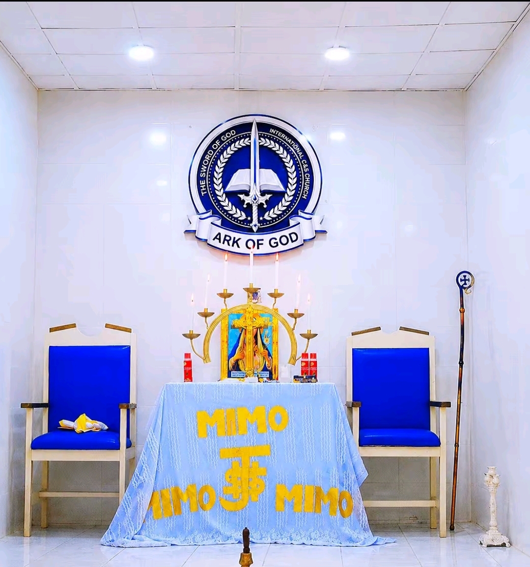 The holy altar of The Sword of God International Church, dressed in blue with candles and the Ark of God seal above